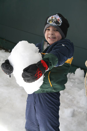 Boy holding snow
